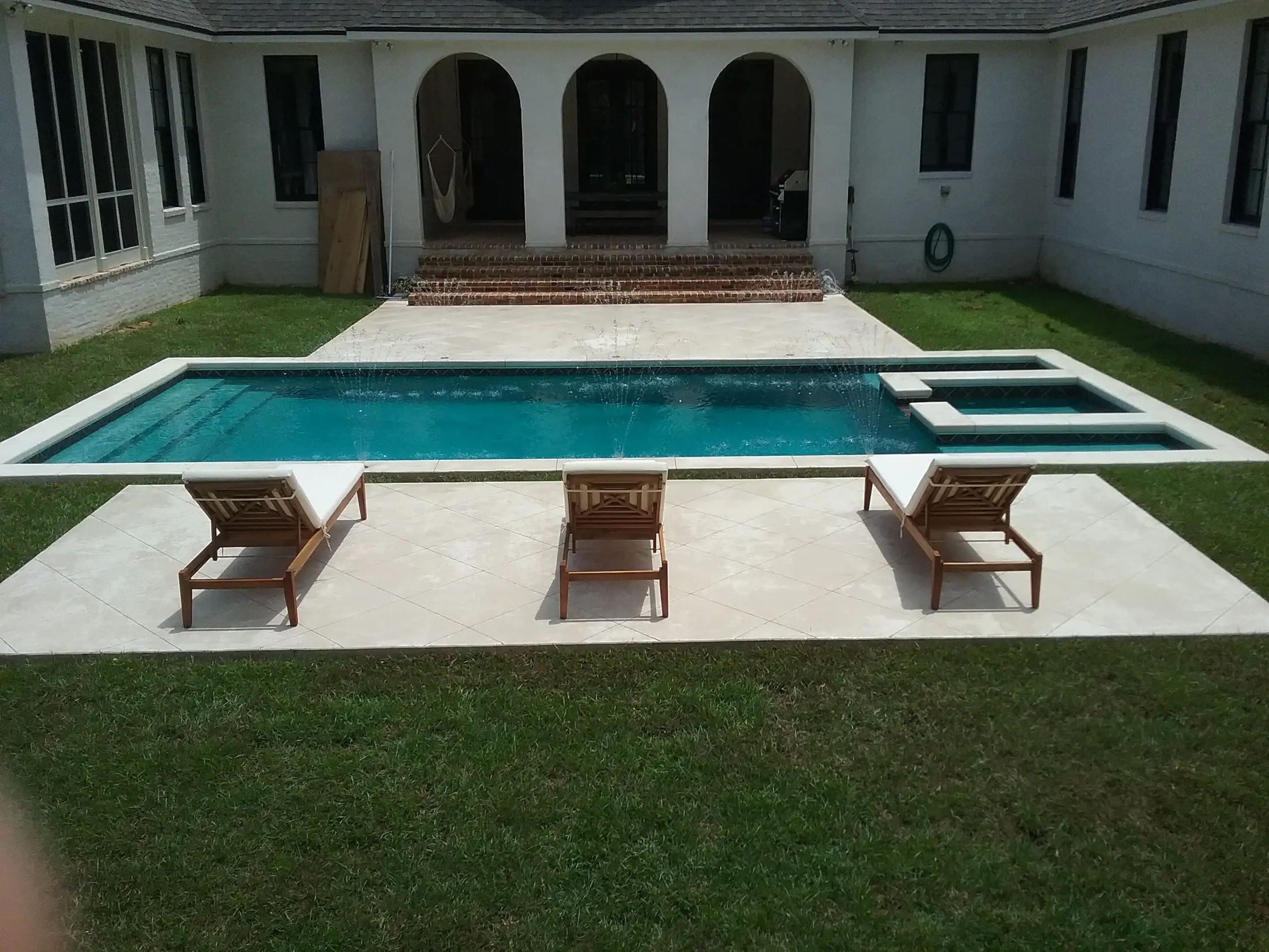 Luxury custom pool and recessed spa designed and built by Clearwater Outdoor Creations